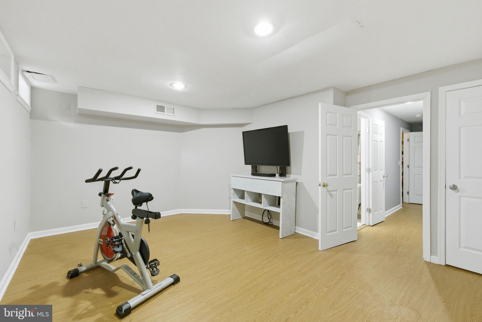 14688 Basingstoke Loop Centreville, VA 20120 - Photo 30 of 34 a view of room with gym equipment and a flat screen tv