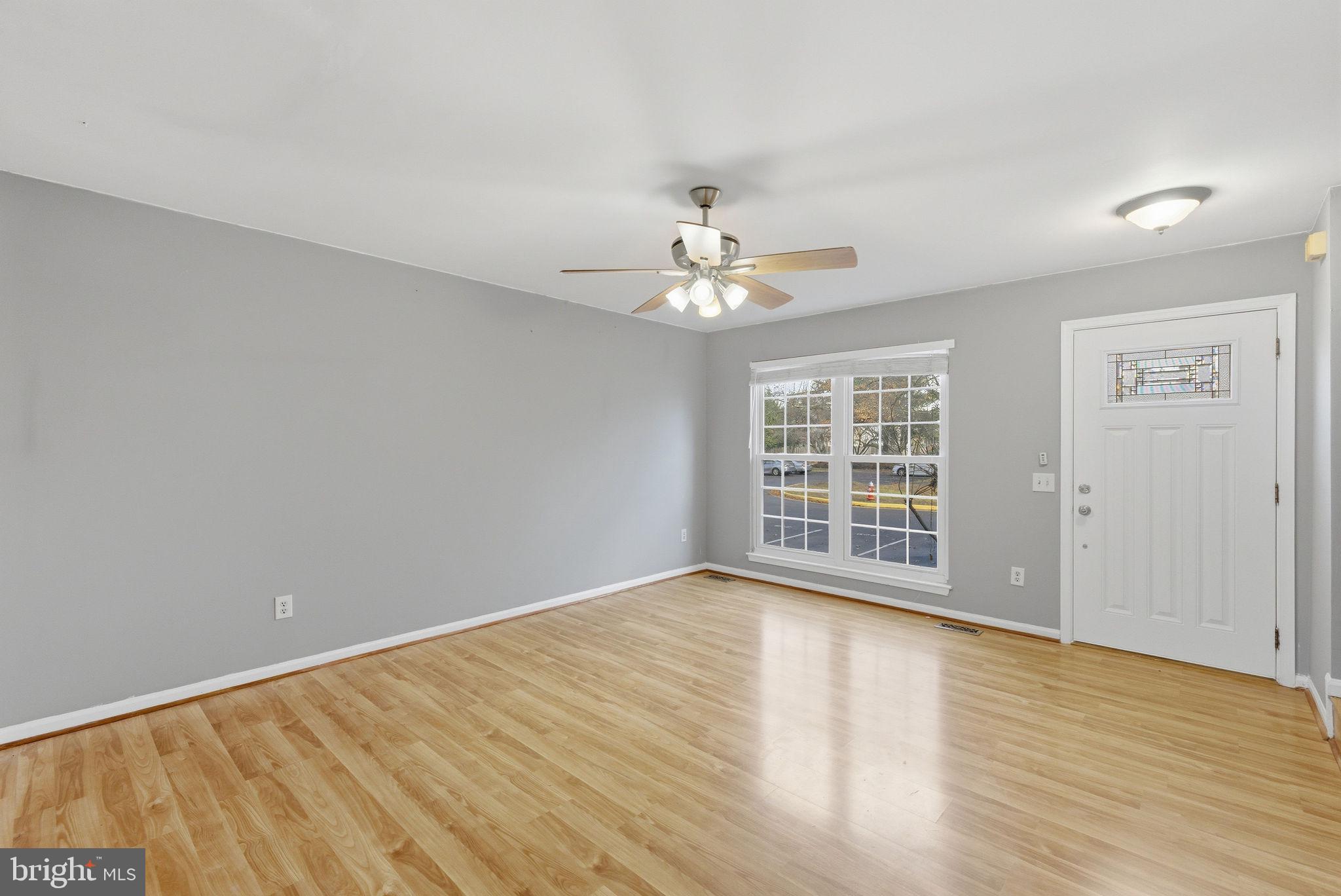 14688 Basingstoke Loop Centreville, VA 20120 - Photo 5 of 34 a view of an empty room with wooden floor and a window