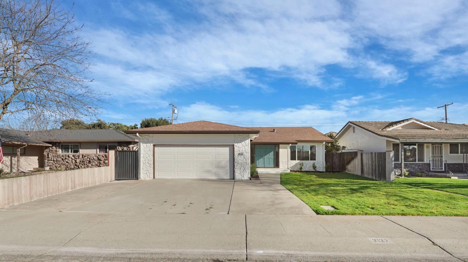 2127 Oxford Way Lodi, CA 95242 - Photo 1 of 1 front view of a house with a yard