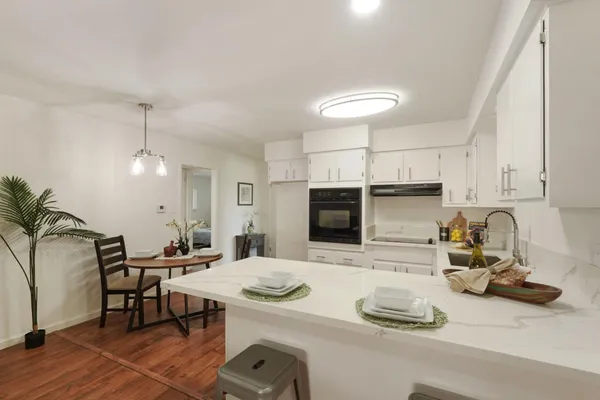 a kitchen with sink a microwave and cabinets