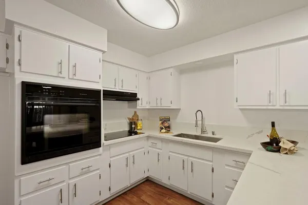 a kitchen with white cabinets and a sink