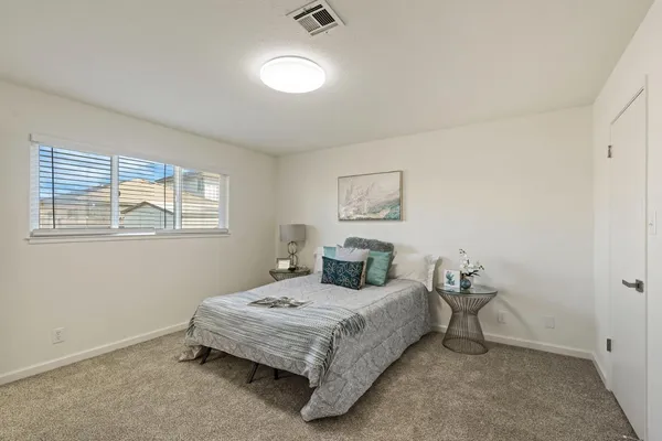 a bedroom with a bed and night stand