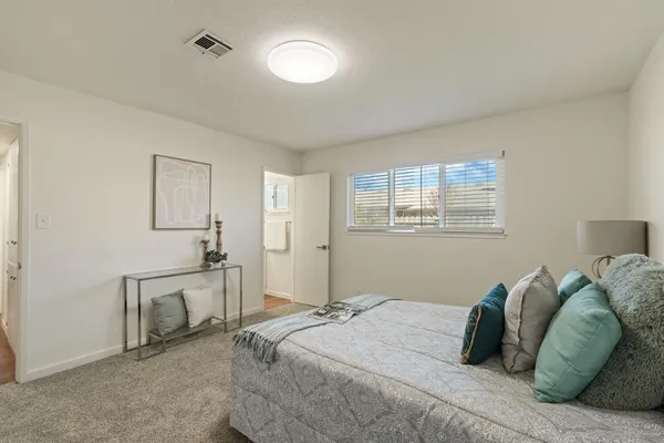 a bedroom with a bed and a window