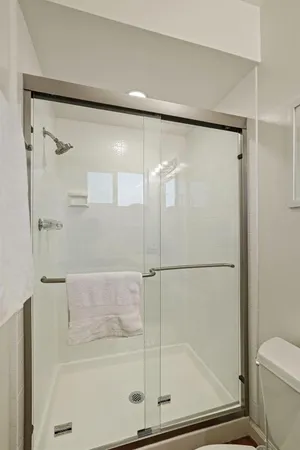a bathroom with a glass shower door