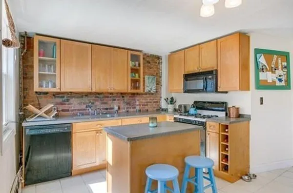 a kitchen with a sink cabinets and wooden floor