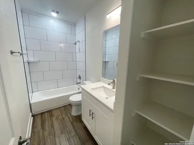 a bathroom with a tub sink toilet and a shower