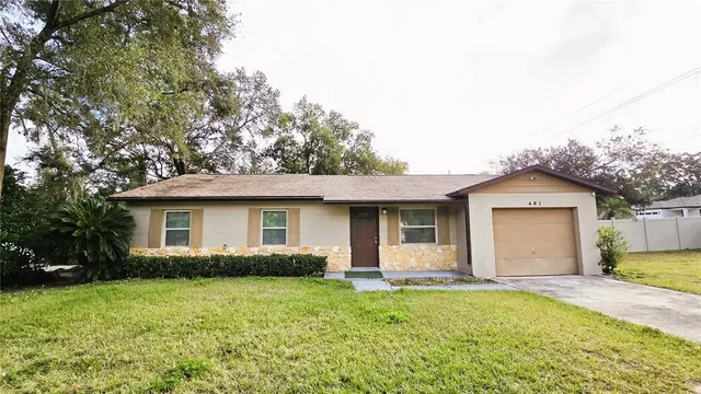 a front view of house with yard and trees