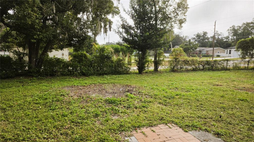 401 Noya Lane Apopka, FL 32712 - Photo 13 of 14 a view of a field of grass and trees