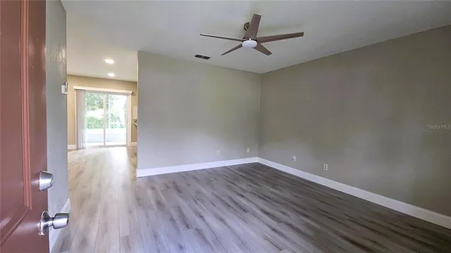 wooden floor in an empty room with a window