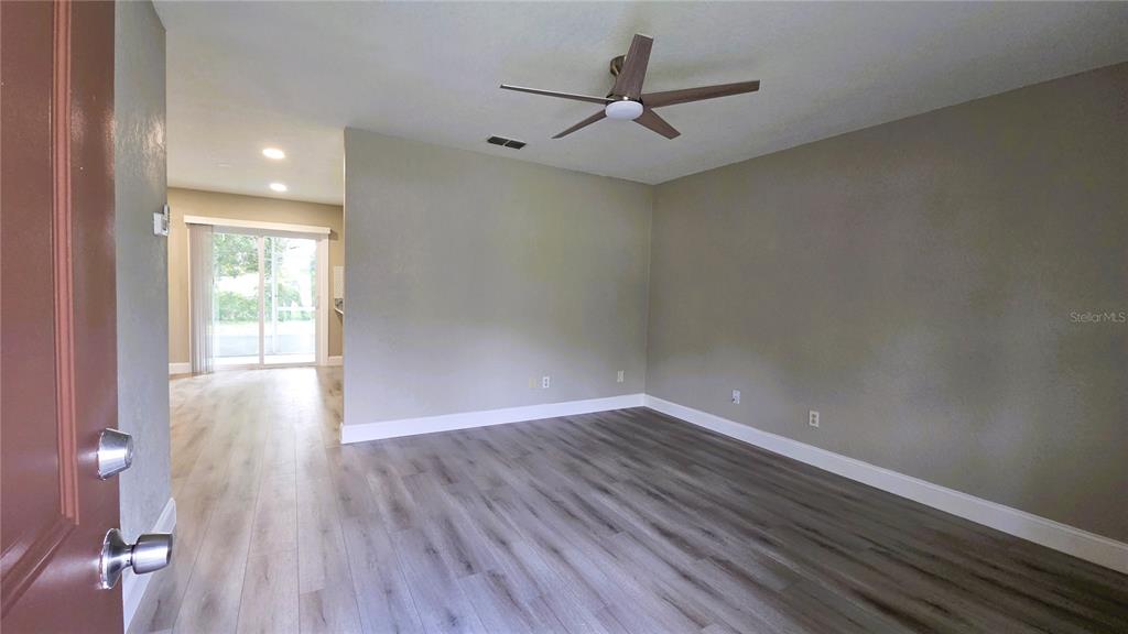401 Noya Lane Apopka, FL 32712 - Photo 4 of 14 wooden floor in an empty room with a window