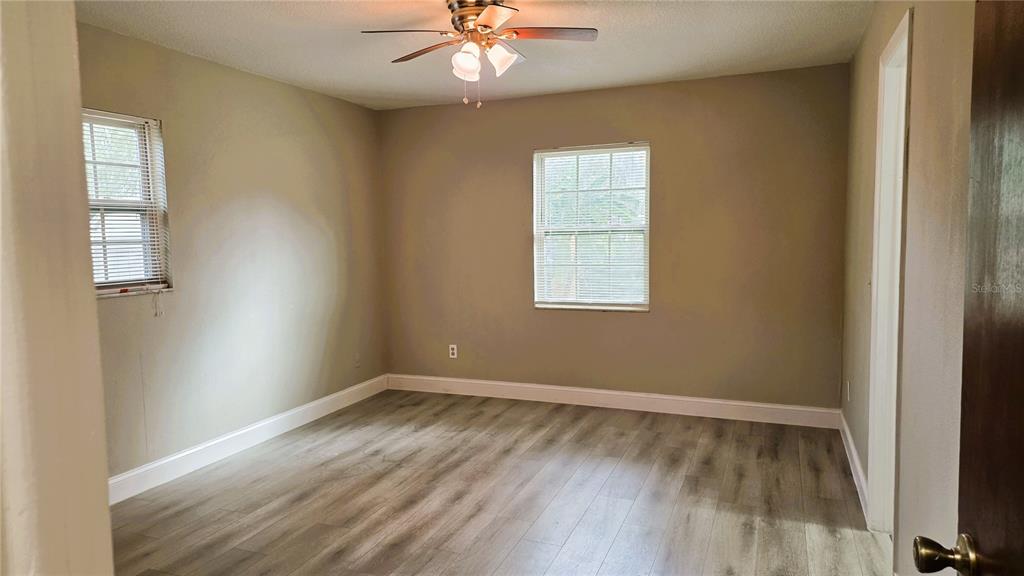 401 Noya Lane Apopka, FL 32712 - Photo 7 of 14 an empty room with a window and wooden floor