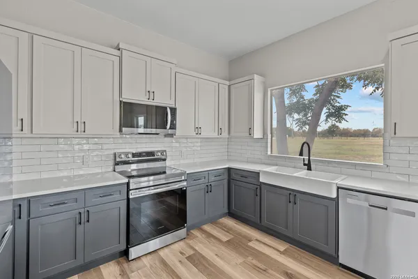 a kitchen with a sink stove and microwave