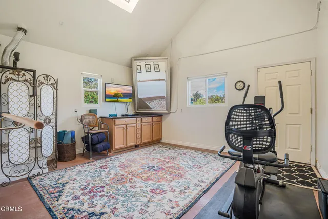 an aerial view of a house with a garden and lake view
