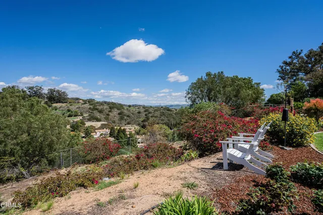 a view of a porch with chairs and backyard