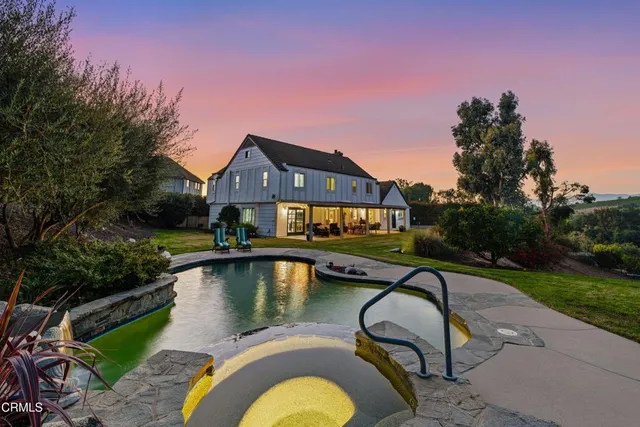 a living room with furniture a fireplace and a large window