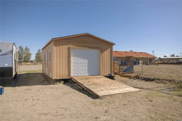 a view of a house with a big yard and large trees