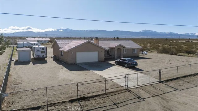 an aerial view of a houses with yard