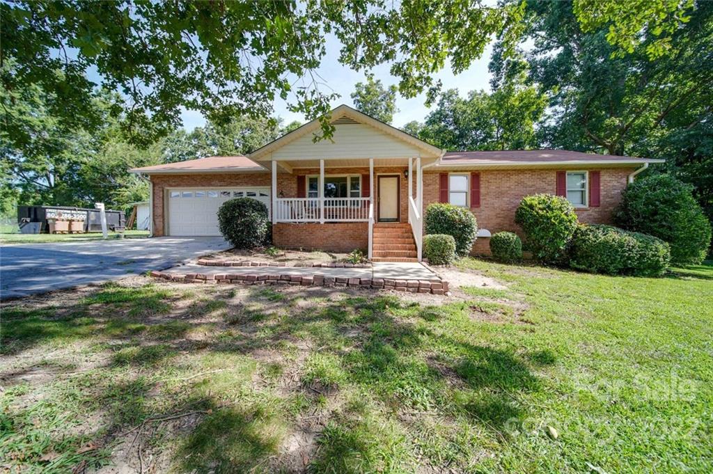 3210 Trinity Church Road Monroe, NC 28112 - Photo 1 of 29 a front view of a house with yard and green space