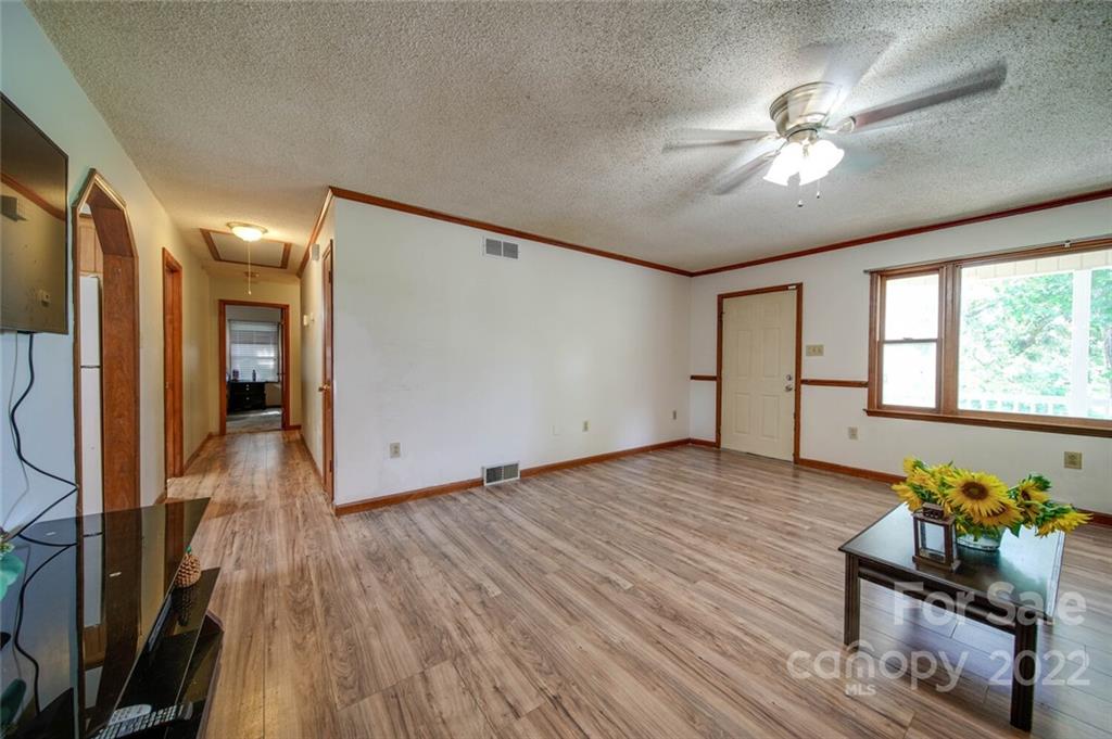 3210 Trinity Church Road Monroe, NC 28112 - Photo 11 of 29 a view of an empty room with wooden floor and a window