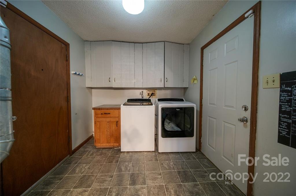 3210 Trinity Church Road Monroe, NC 28112 - Photo 18 of 29 a utility room with wooden floor washer and dryer