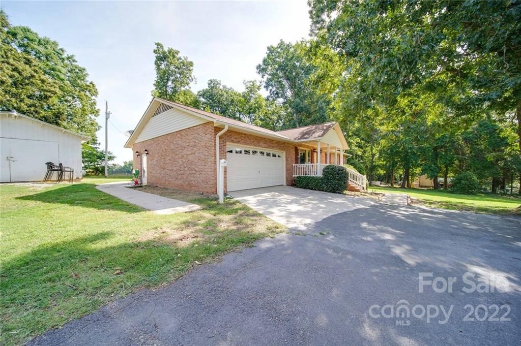 3210 Trinity Church Road Monroe, NC 28112 - Photo 2 of 29 a front view of a house with a yard and garage