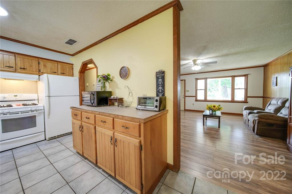 3210 Trinity Church Road Monroe, NC 28112 - Photo 23 of 29 a kitchen with stainless steel appliances granite countertop a stove a sink and a refrigerator