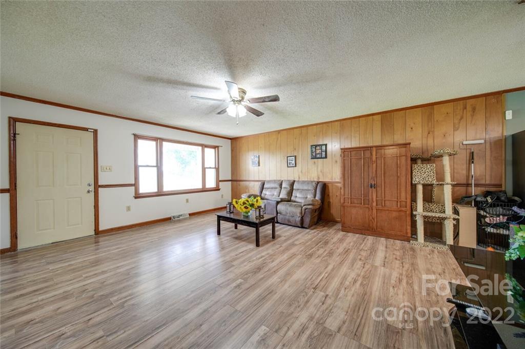 3210 Trinity Church Road Monroe, NC 28112 - Photo 25 of 29 a living room with furniture and a chandelier