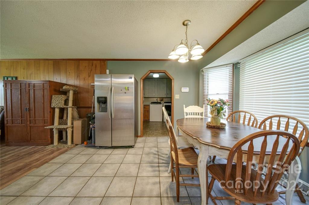3210 Trinity Church Road Monroe, NC 28112 - Photo 28 of 29 a kitchen with stainless steel appliances granite countertop a dining table and chairs