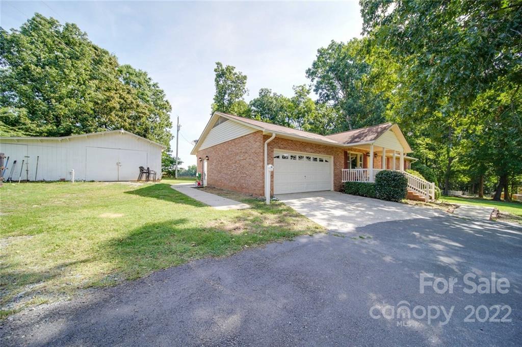 3210 Trinity Church Road Monroe, NC 28112 - Photo 3 of 29 a view of a house with a yard and garage