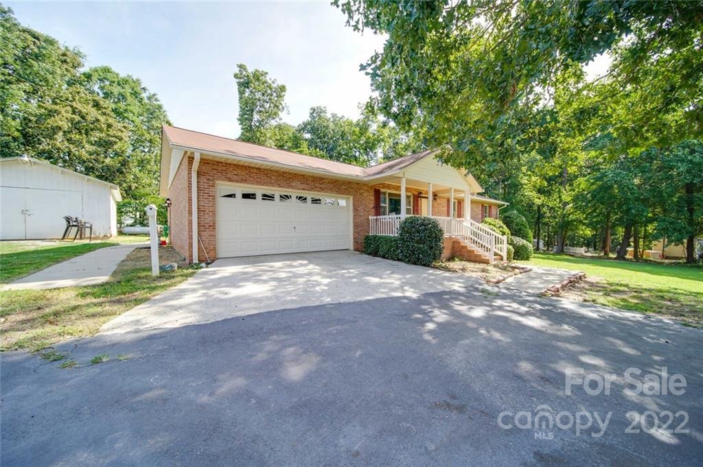 3210 Trinity Church Road Monroe, NC 28112 - Photo 4 of 29 a view of a house with a yard and large trees