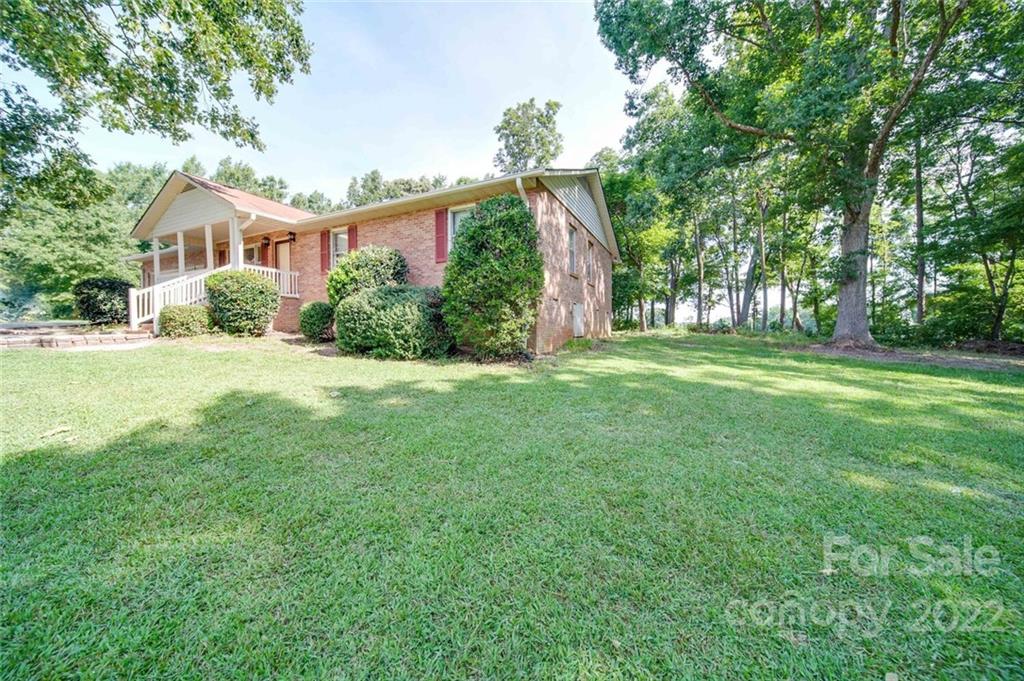 3210 Trinity Church Road Monroe, NC 28112 - Photo 5 of 29 a front view of a house with a yard and trees