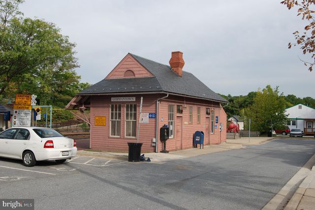 a view of a cars park in front of a building