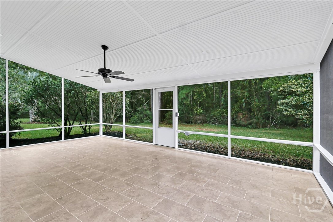 29 Hamilton Drive Bluffton, SC 29909 - Photo 16 of 33 Oversized screened porch, featuring tiled flooring and views of the private wooded backyard