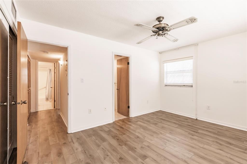 4158 Tamiami Trail, Unit S6 Port Charlotte, FL 33952 - Photo 14 of 39 wooden floor in an empty room with a window