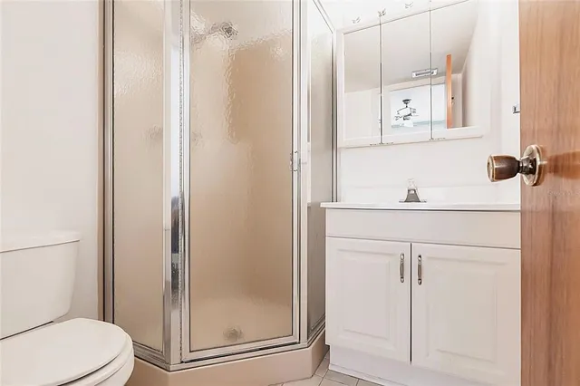 a bathroom with a shower a toilet and a sink