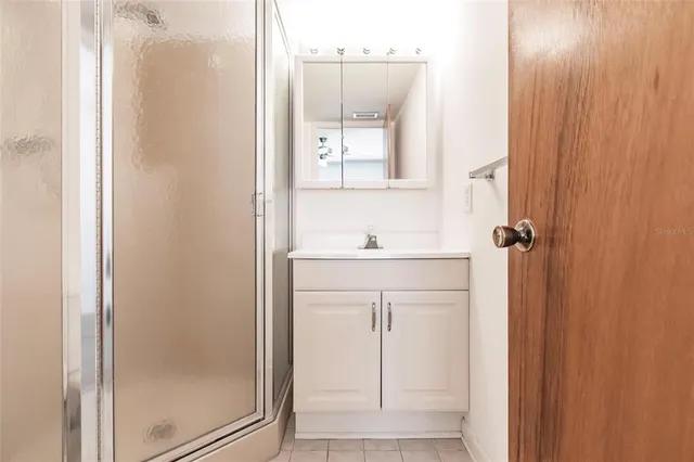 a bathroom with a sink a mirror and shower