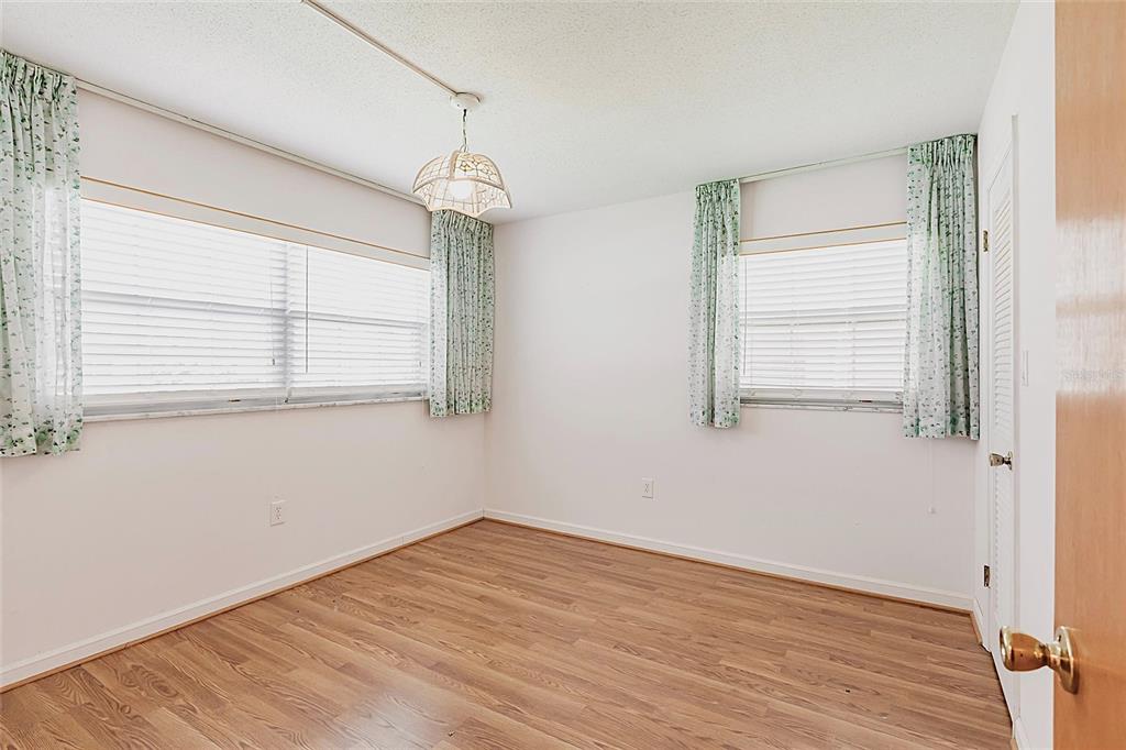 4158 Tamiami Trail, Unit S6 Port Charlotte, FL 33952 - Photo 19 of 39 a view of empty room with wooden floor and fan
