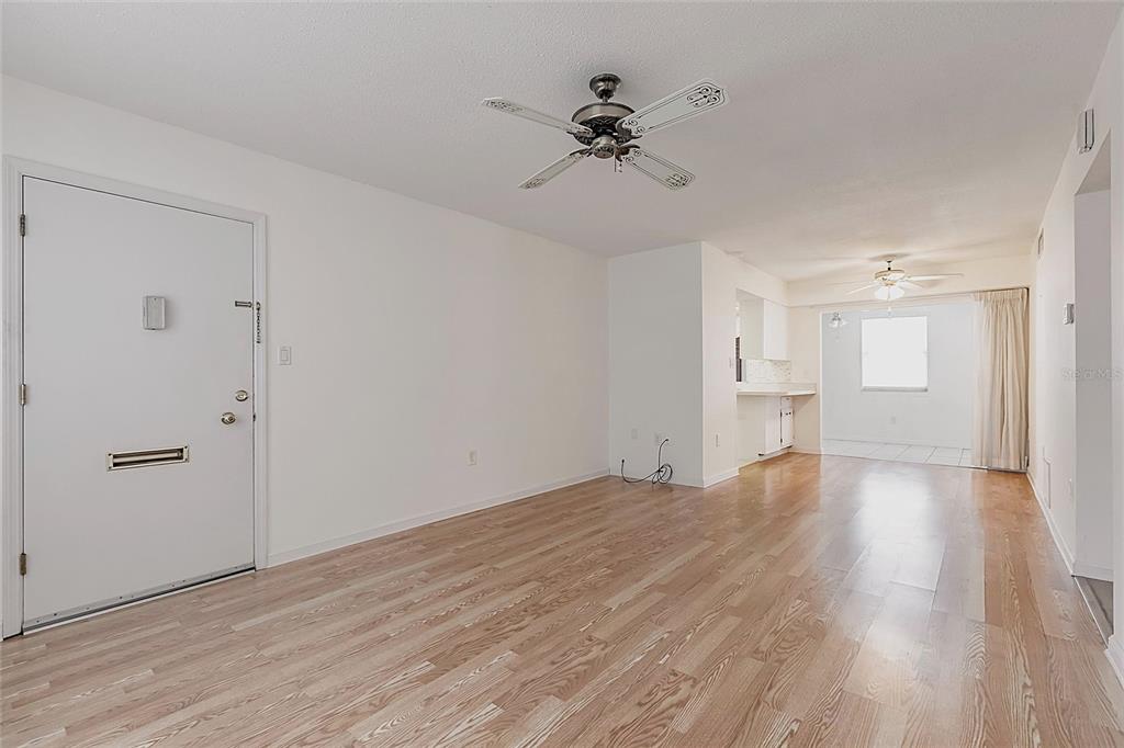 4158 Tamiami Trail, Unit S6 Port Charlotte, FL 33952 - Photo 4 of 39 a view of empty room with wooden floor and window