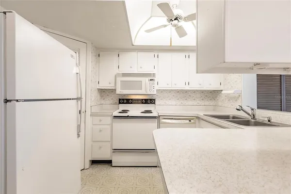 a kitchen with stainless steel appliances cabinets a sink and a window