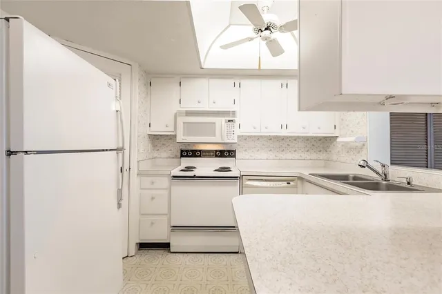 a kitchen with stainless steel appliances cabinets a sink and a window