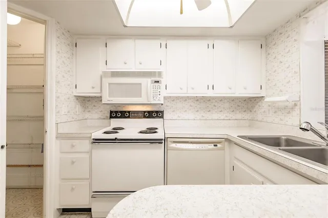 a kitchen with cabinets appliances and a sink