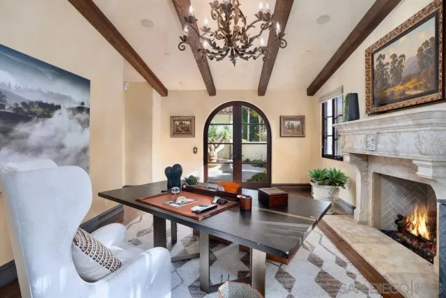 a living room with furniture a fireplace and a large window