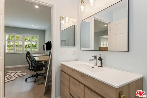 a view of a bathroom with dual sinks