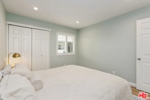 a bedroom with a bed and window