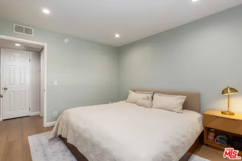 a bedroom with a bed and lamps