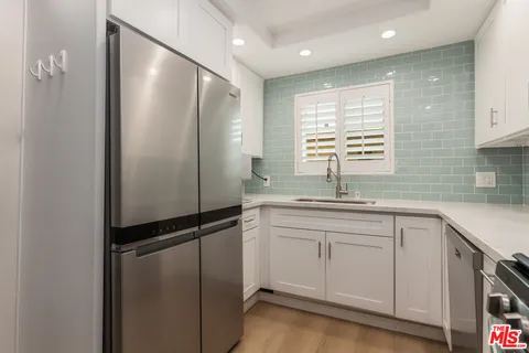 a kitchen with a sink and refrigerator