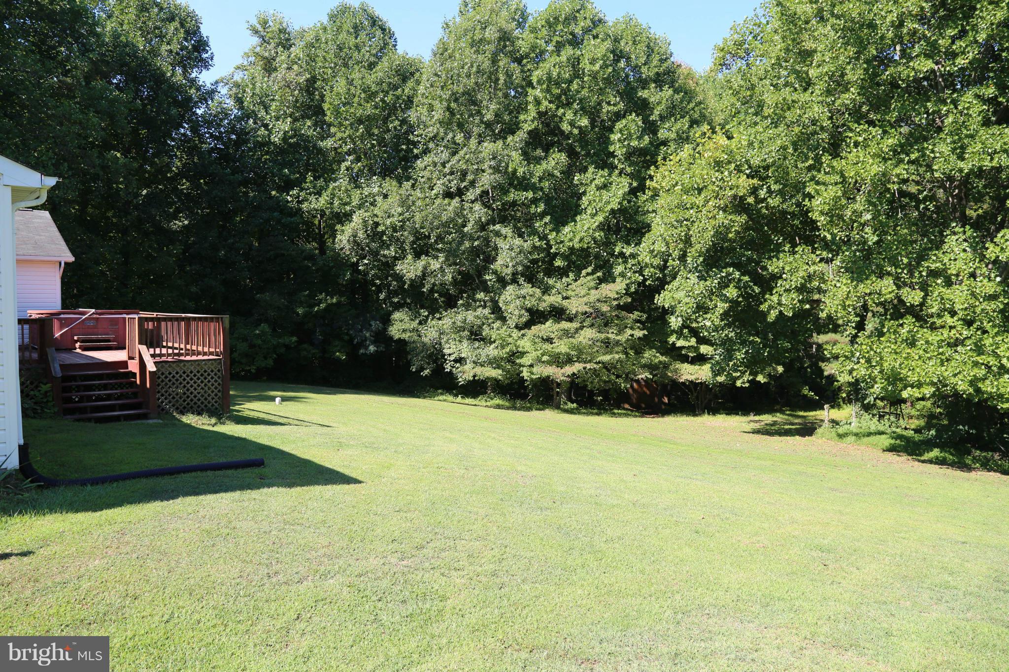 1190 Plum Point Road Huntingtown, MD 20639 - Photo 3 of 20 a view of a yard with an outdoor space