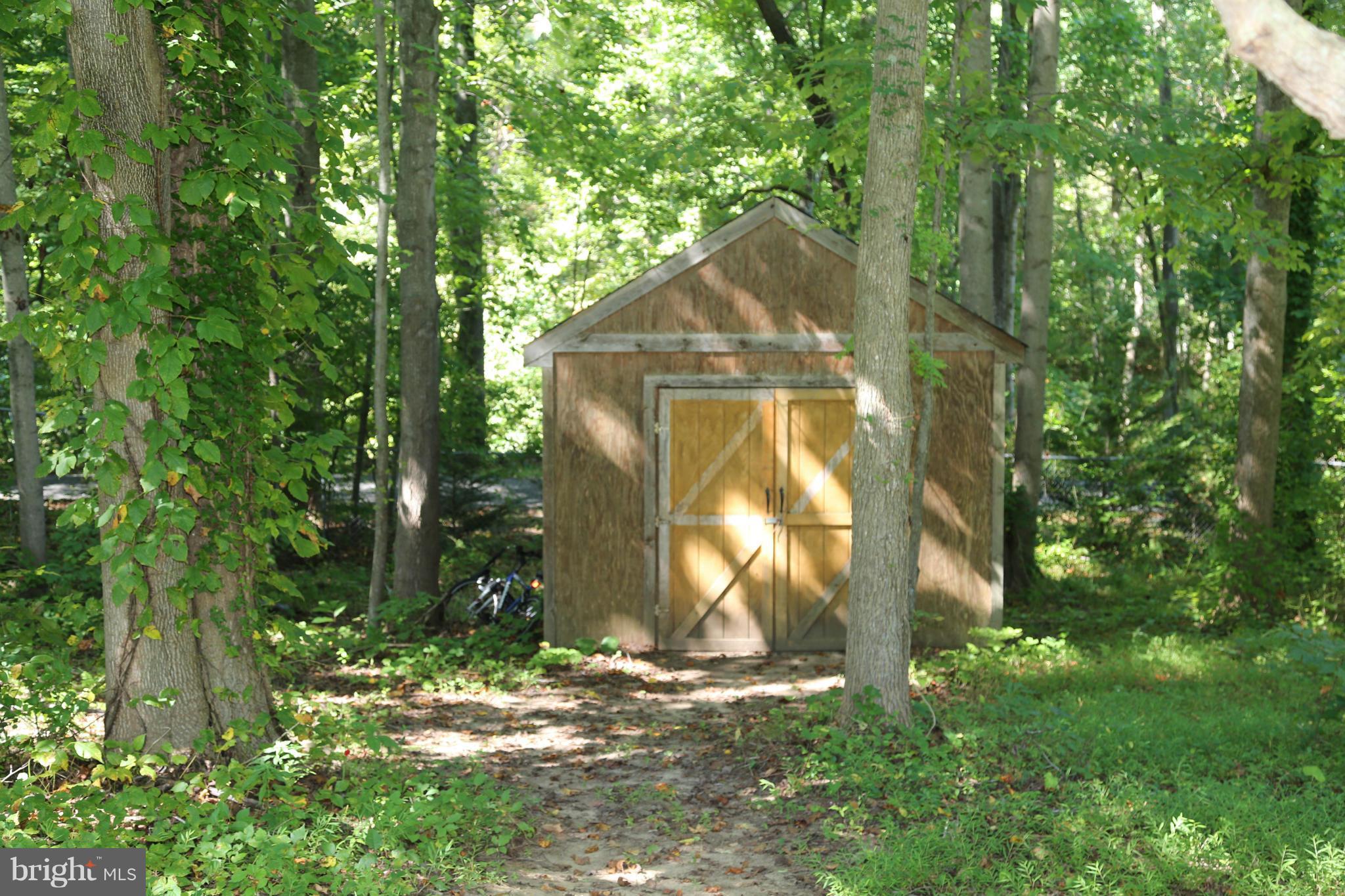 1190 Plum Point Road Huntingtown, MD 20639 - Photo 5 of 20 a backyard of a house with barbeque oven table and chairs
