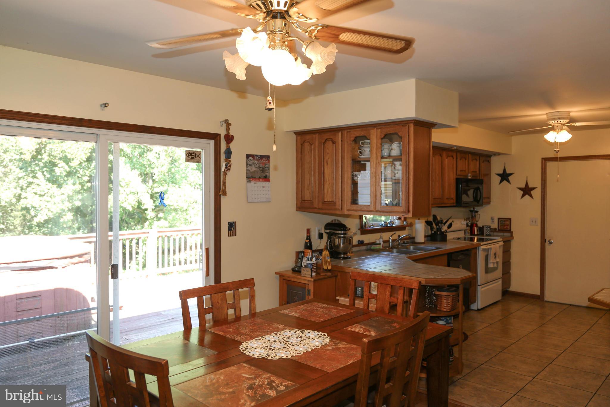 1190 Plum Point Road Huntingtown, MD 20639 - Photo 7 of 20 a view of a dining room with furniture window and outside view