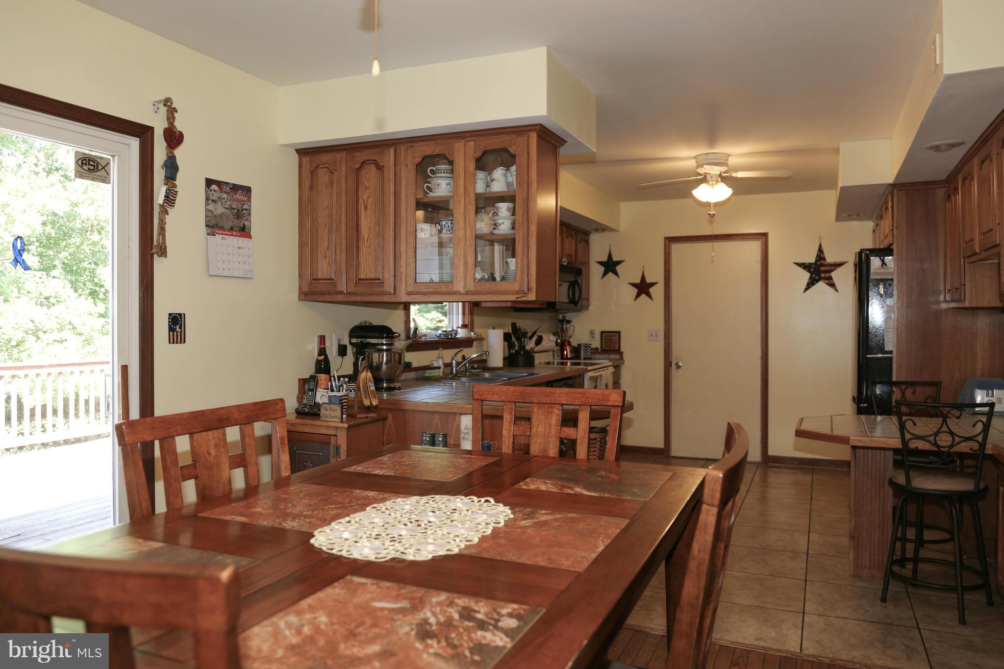1190 Plum Point Road Huntingtown, MD 20639 - Photo 8 of 20 a dining room with furniture and a kitchen view